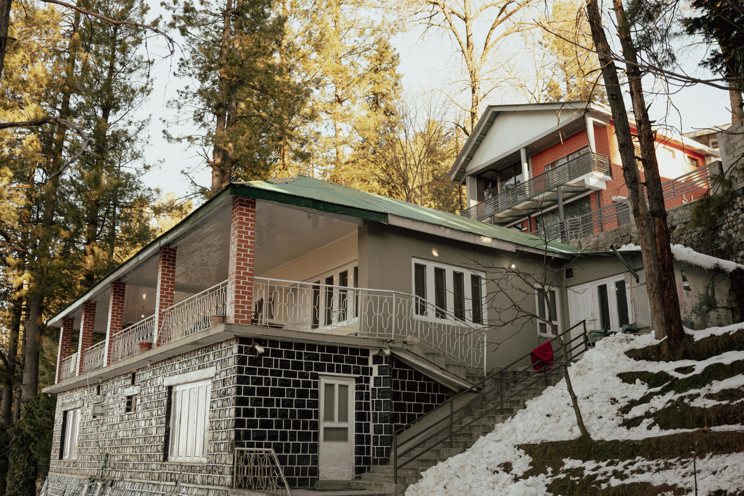 A picturesque house nestled in a snowy forest during winter.
